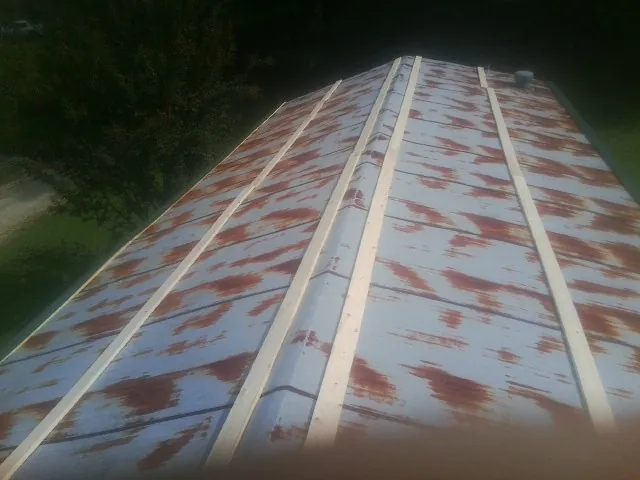 Rusted metal roof panels with new wood purlins before replacement — Storm Damage Roof Repair in Church Creek by Roofing Brothers